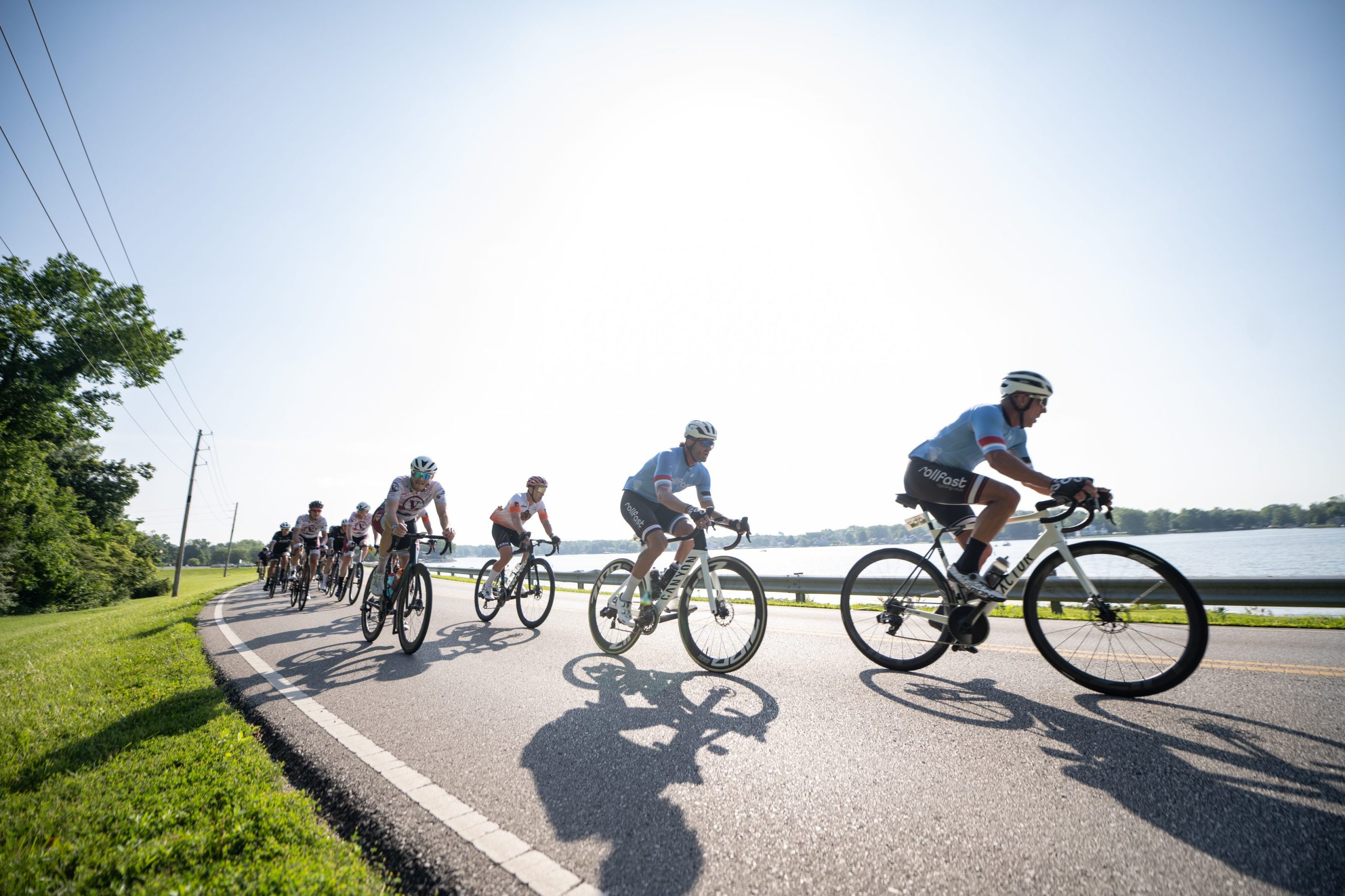 Rollfast club paceline riding along the lake at sunrise